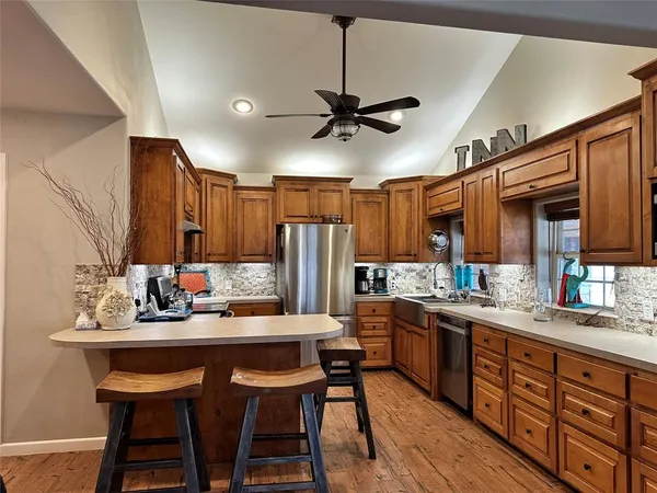 a kitchen with a sink cabinets and wooden floor