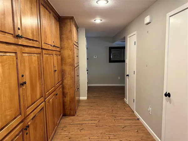 a view of a hallway with wooden floor