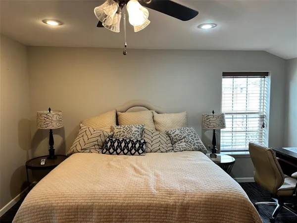 a bedroom with a bed and chair