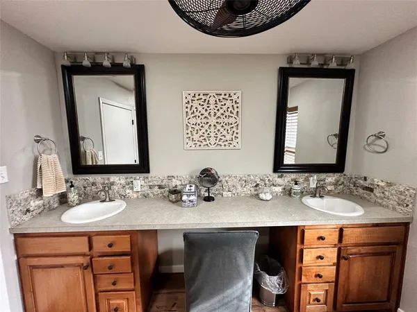 a bathroom with a sink double vanity and a mirror