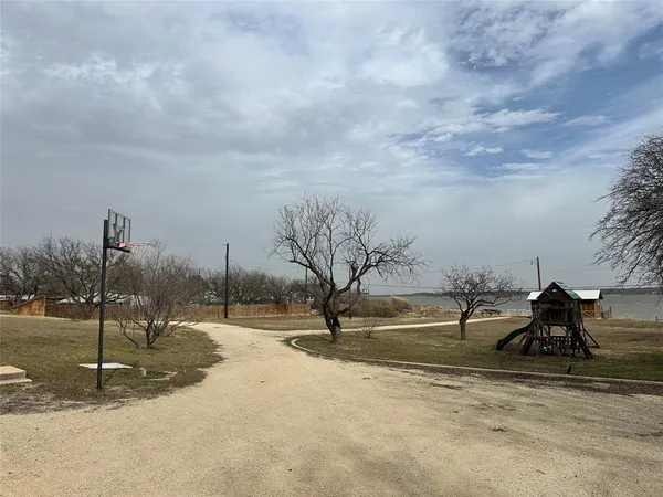 a view of outdoor space with playground and green space