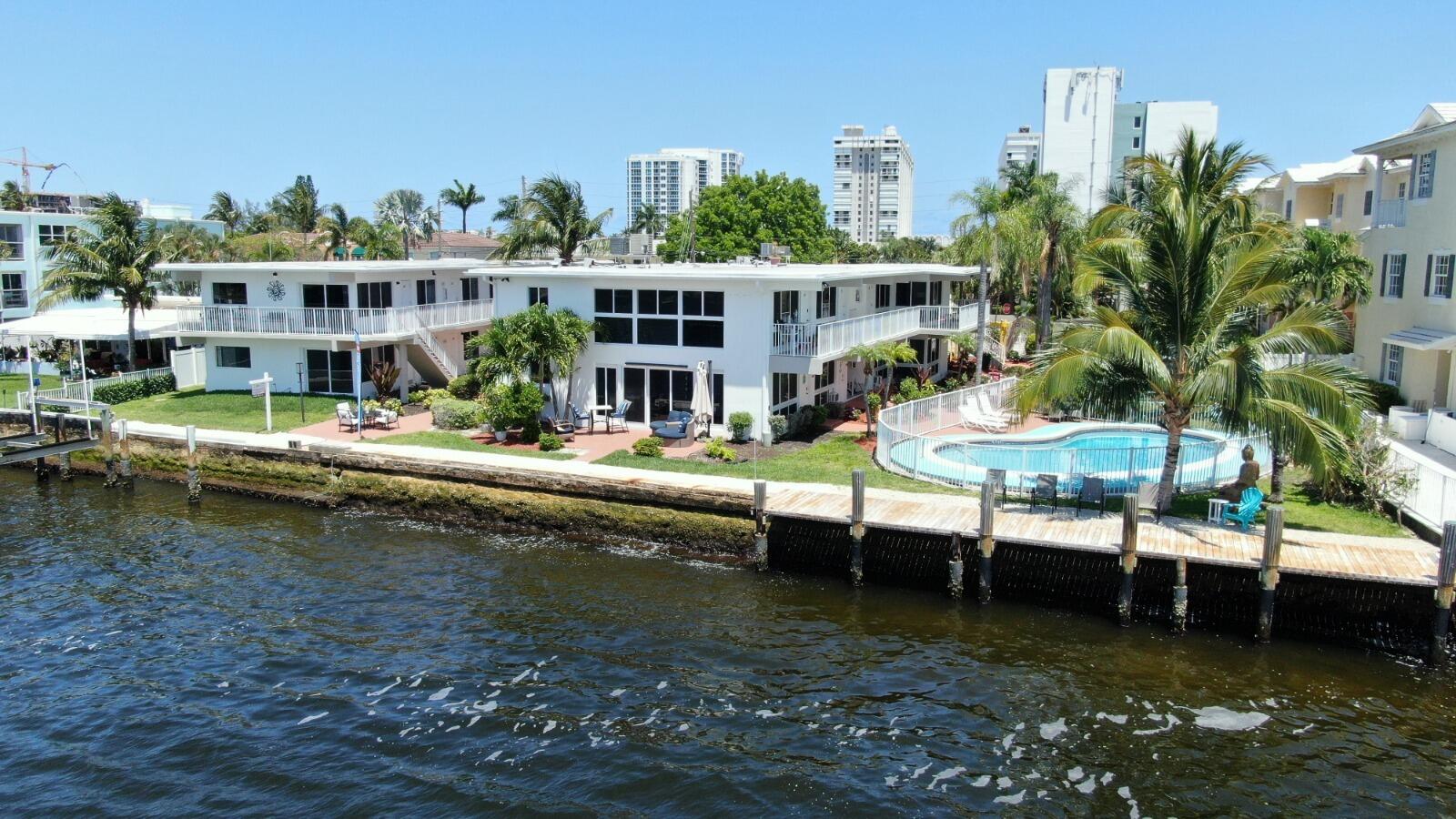 1001 South Riverside Drive, Unit 104 Pompano Beach, FL 33062 - Photo 2 of 6 a view of swimming pool with outdoor seating and city view
