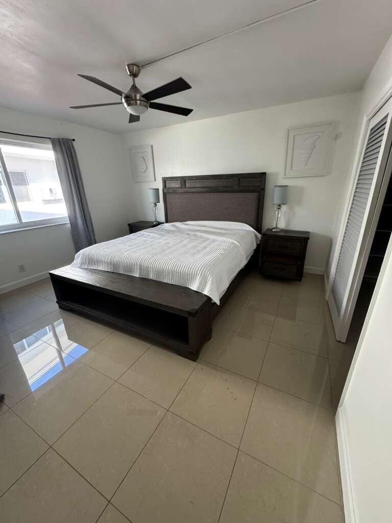 1001 South Riverside Drive, Unit 104 Pompano Beach, FL 33062 - Photo 5 of 6 a bedroom with a bed and a window