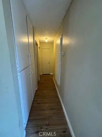 a view of hallway with wooden floor