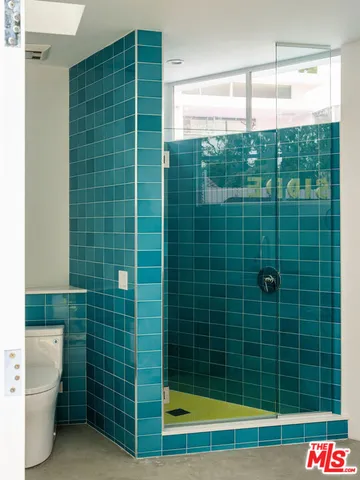 a front view of a house with a yard and potted plants