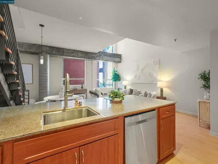 a kitchen with stainless steel appliances granite countertop a sink and a refrigerator