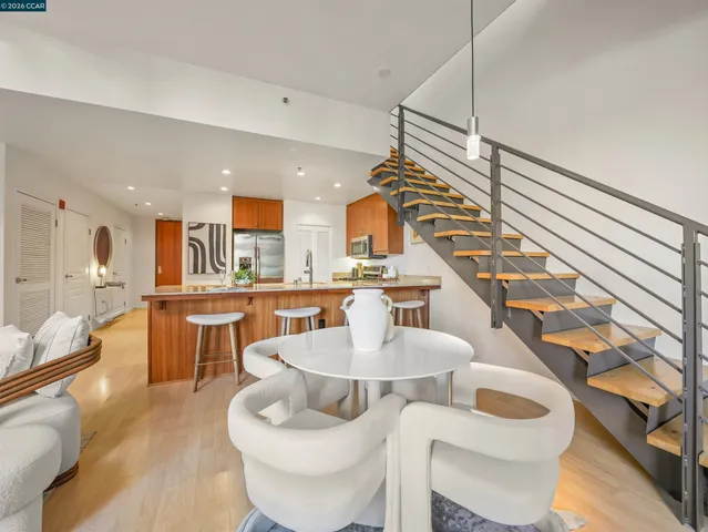 a large kitchen with a table and chairs