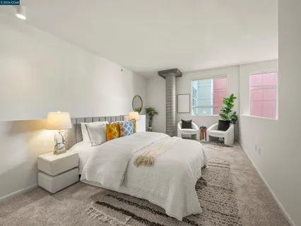 a bedroom with a bed and a lamp