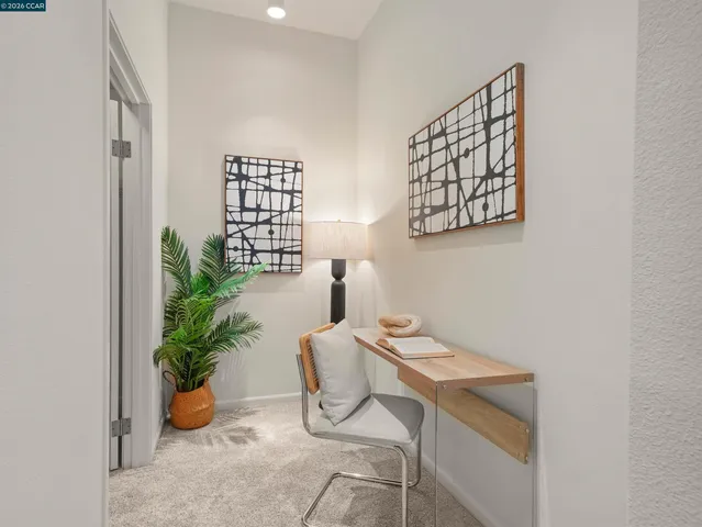 a reading room with furniture and a potted plant
