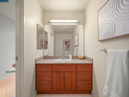 a bathroom with a granite countertop sink and a mirror