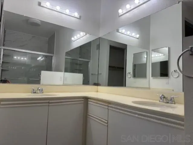 a bathroom with a sink and a large mirror