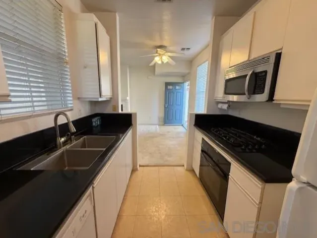 a kitchen with stainless steel appliances granite countertop a sink and stove top oven with granite countertops
