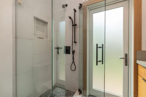 a bathroom with a glass shower door
