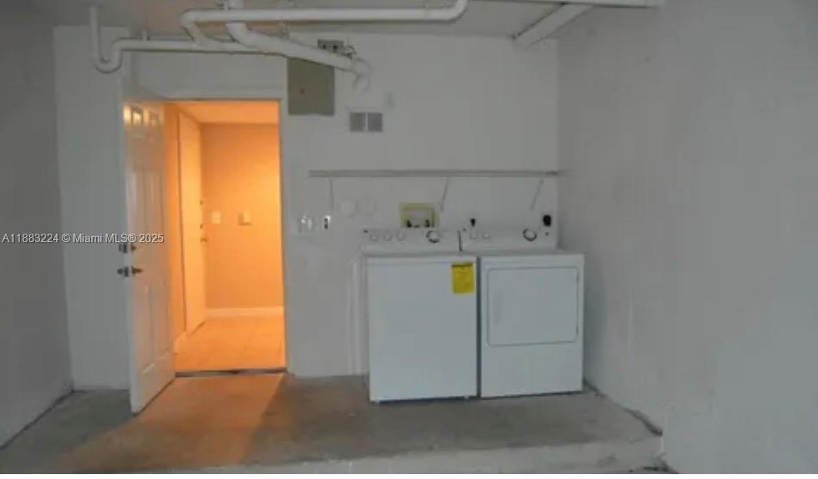 4183 Haverhill Road, Unit 703 West Palm Beach, FL 33417 - Photo 12 of 14 a utility room with dryer and washer