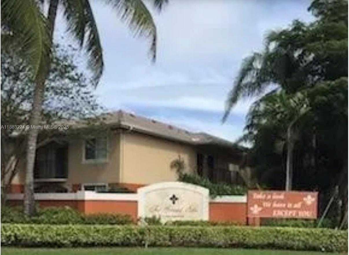 4183 Haverhill Road, Unit 703 West Palm Beach, FL 33417 - Photo 13 of 14 a view of a house with a yard