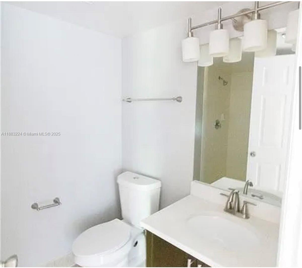 4183 Haverhill Road, Unit 703 West Palm Beach, FL 33417 - Photo 6 of 14 a bathroom with a sink a toilet and shower