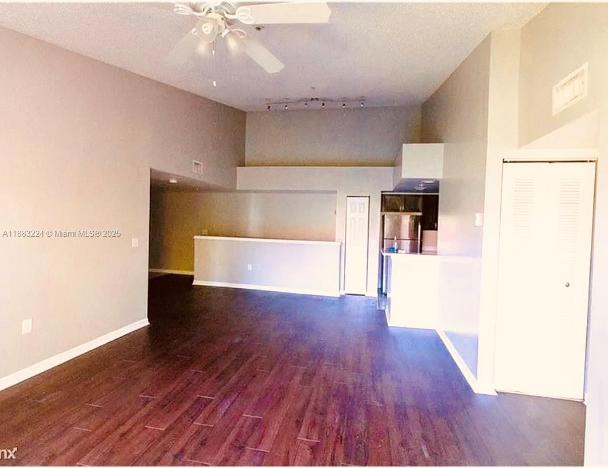 4183 Haverhill Road, Unit 703 West Palm Beach, FL 33417 - Photo 9 of 14 a view of a kitchen with wooden floor