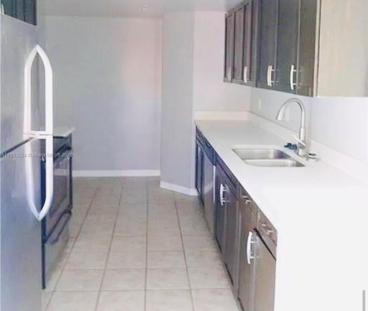 4183 Haverhill Road, Unit 703 West Palm Beach, FL 33417 - Photo 10 of 14 a bathroom with a double vanity sink and mirror