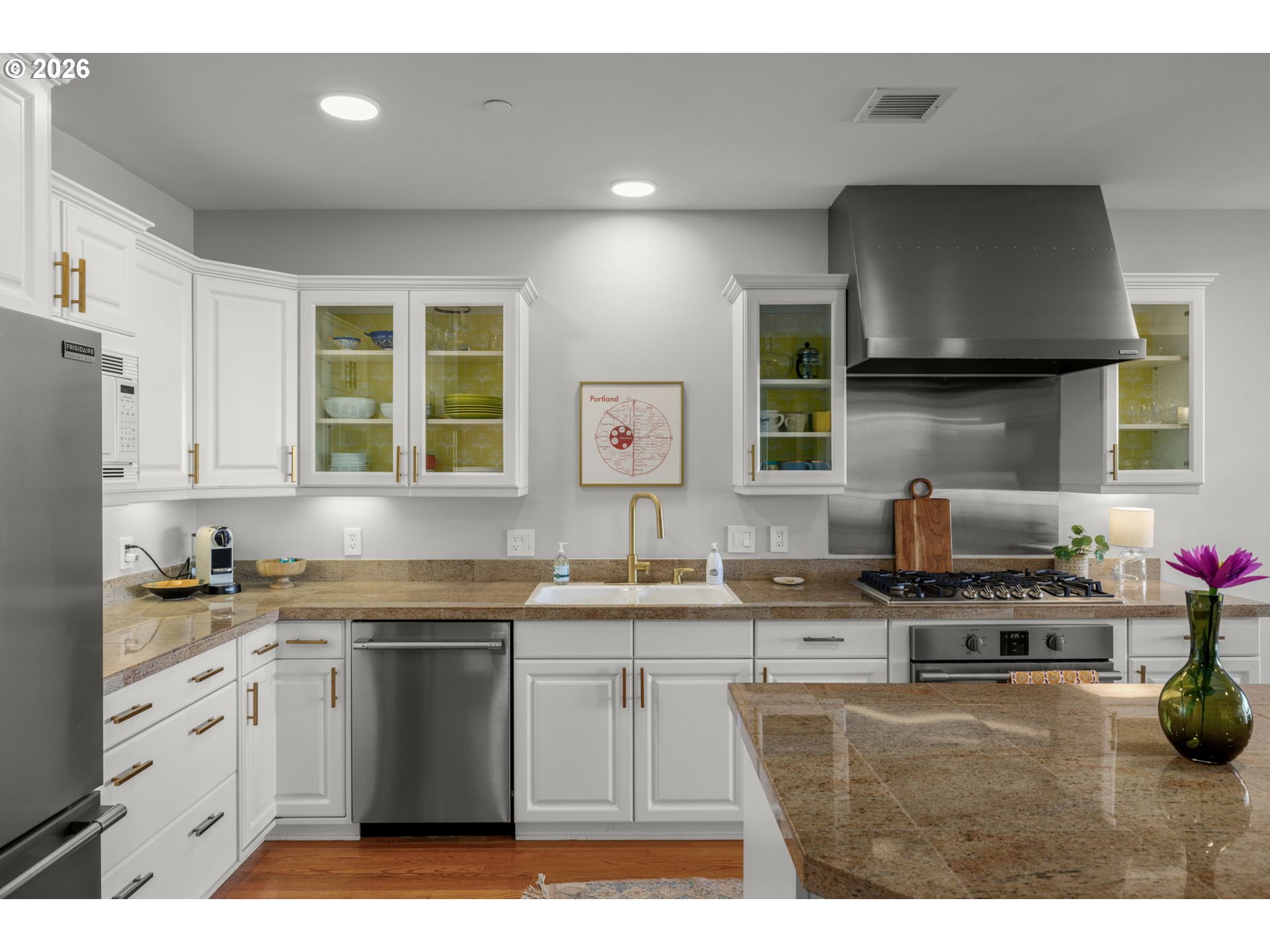 2020 Southwest Market St Drive, Unit 303 Portland, OR 97201 - Photo 13 of 31 a kitchen with stainless steel appliances a sink a stove a microwave a sink and cabinets