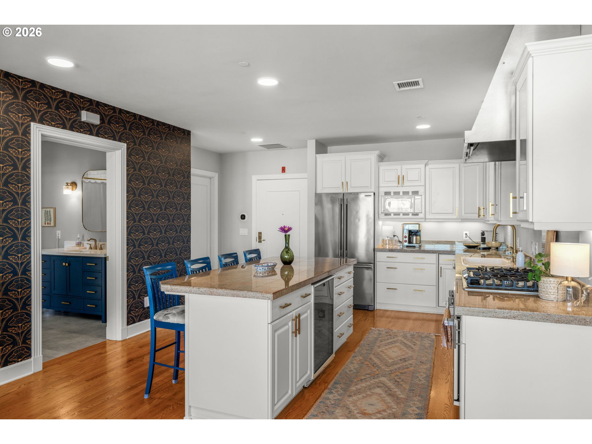 2020 Southwest Market St Drive, Unit 303 Portland, OR 97201 - Photo 15 of 31 a kitchen with stainless steel appliances kitchen island granite countertop a sink and cabinets