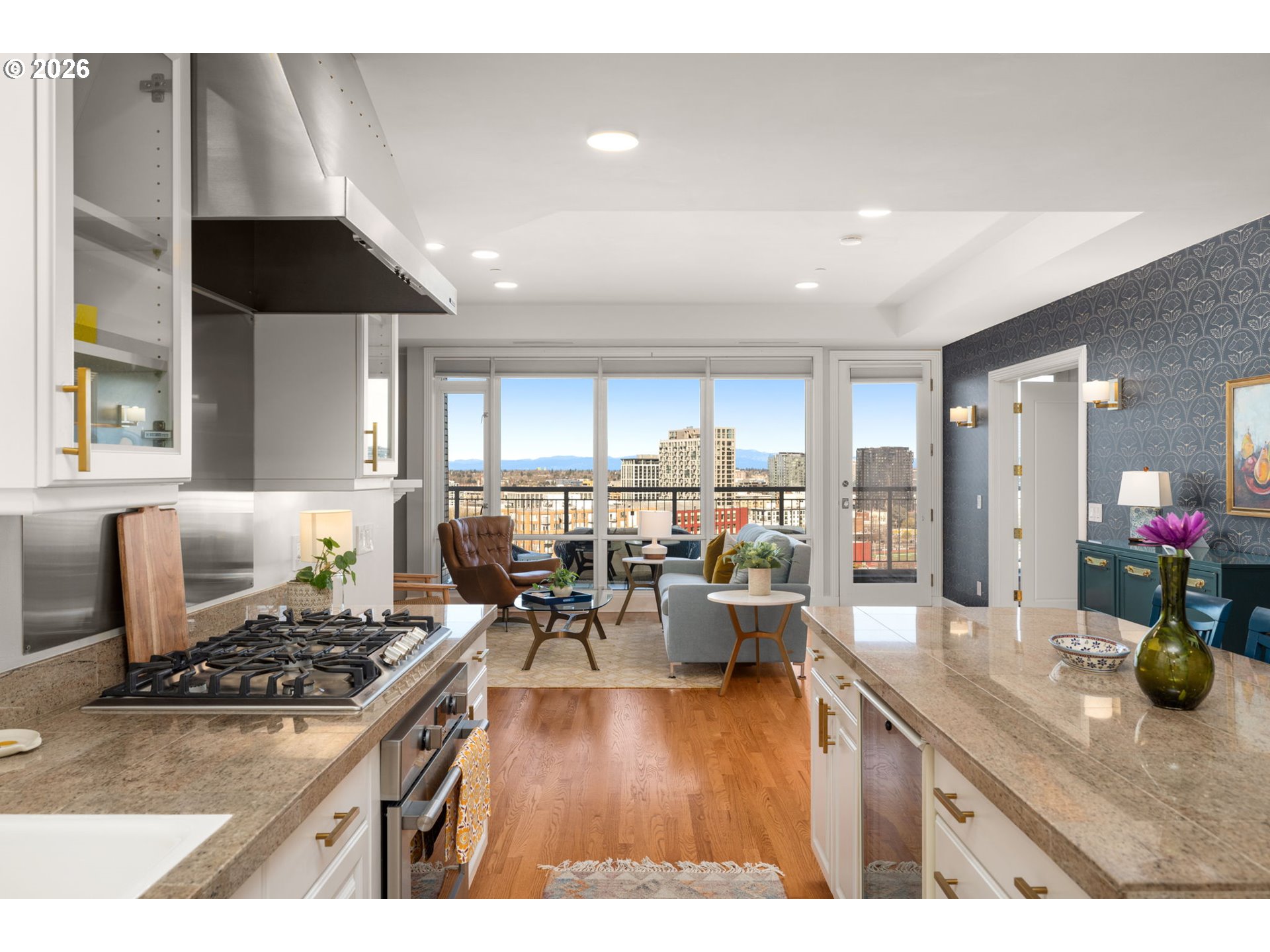 2020 Southwest Market St Drive, Unit 303 Portland, OR 97201 - Photo 16 of 31 a kitchen with a dining table wooden floor and white stainless steel appliances