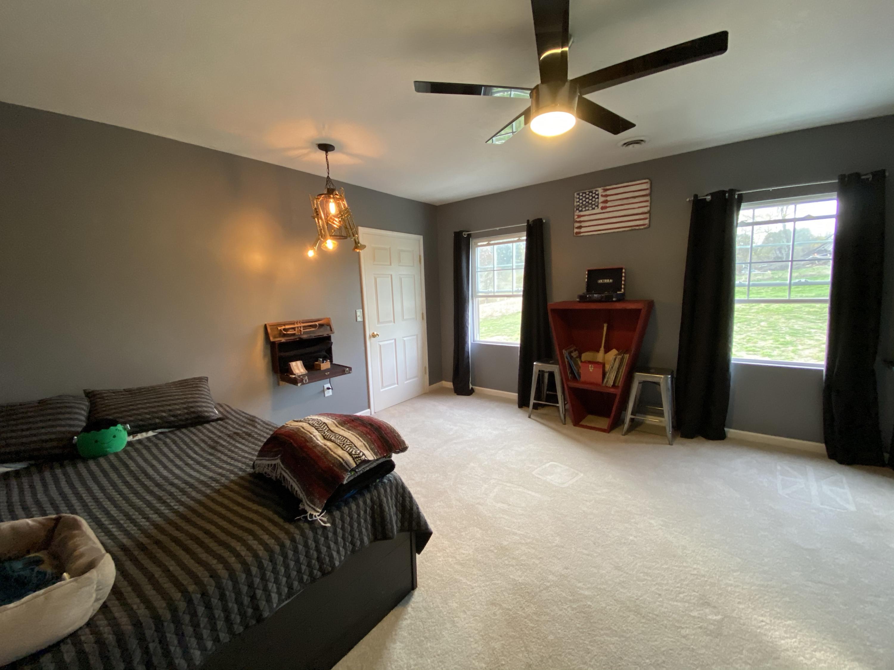 2211 Riner Road Christiansburg, VA 24073 - Photo 11 of 15 a spacious bedroom with a bed and a chandelier