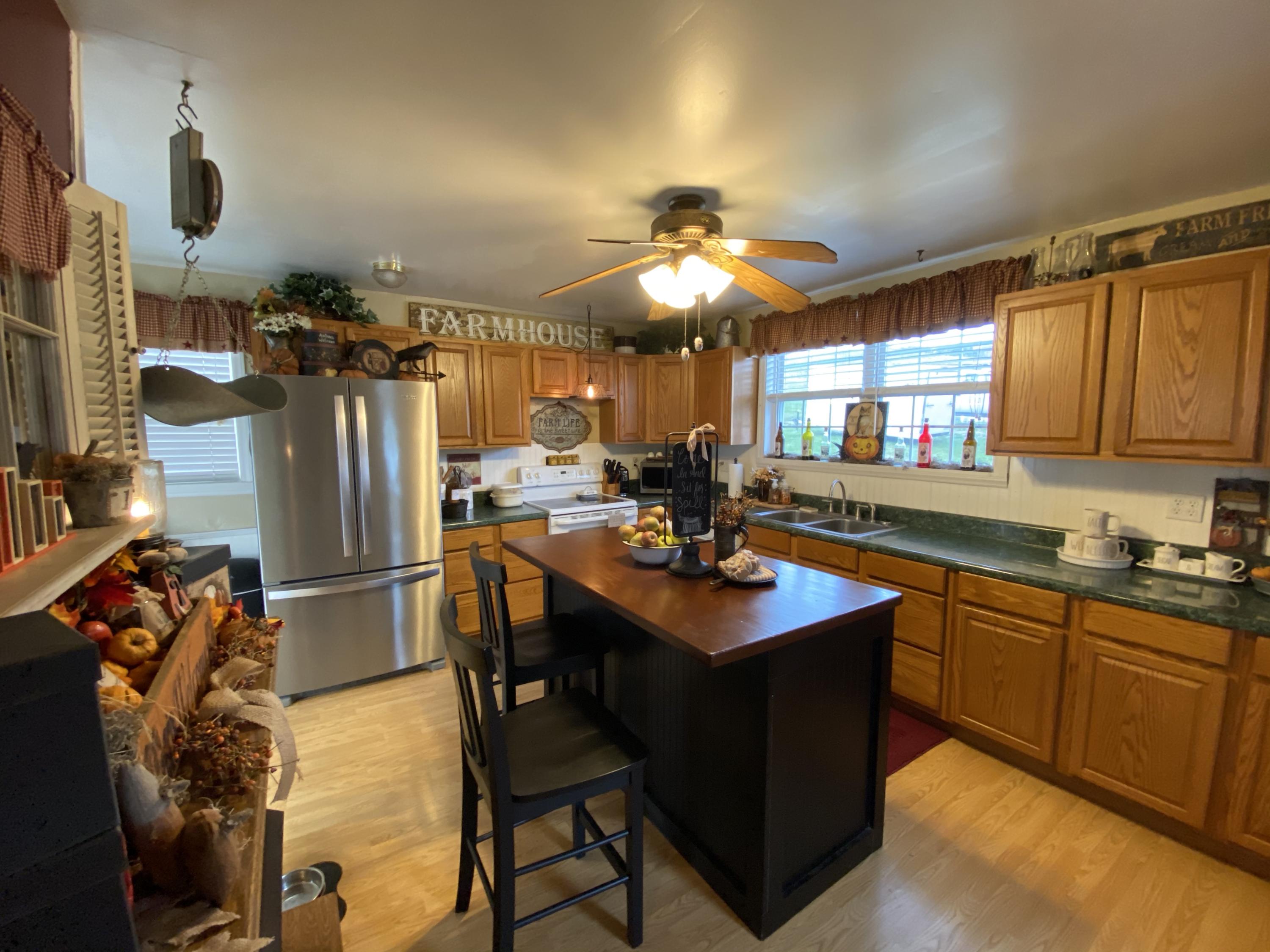2211 Riner Road Christiansburg, VA 24073 - Photo 3 of 15 a kitchen with stainless steel appliances a table chairs and chandelier