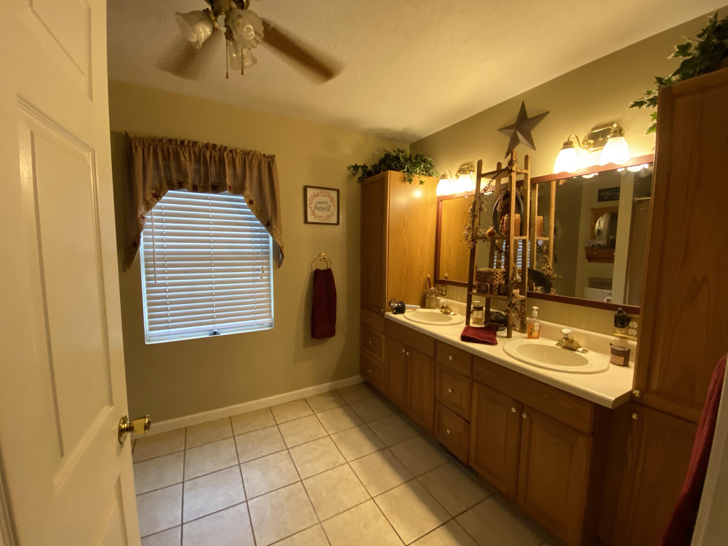 2211 Riner Road Christiansburg, VA 24073 - Photo 9 of 15 a bathroom with a double vanity sink mirror and shower