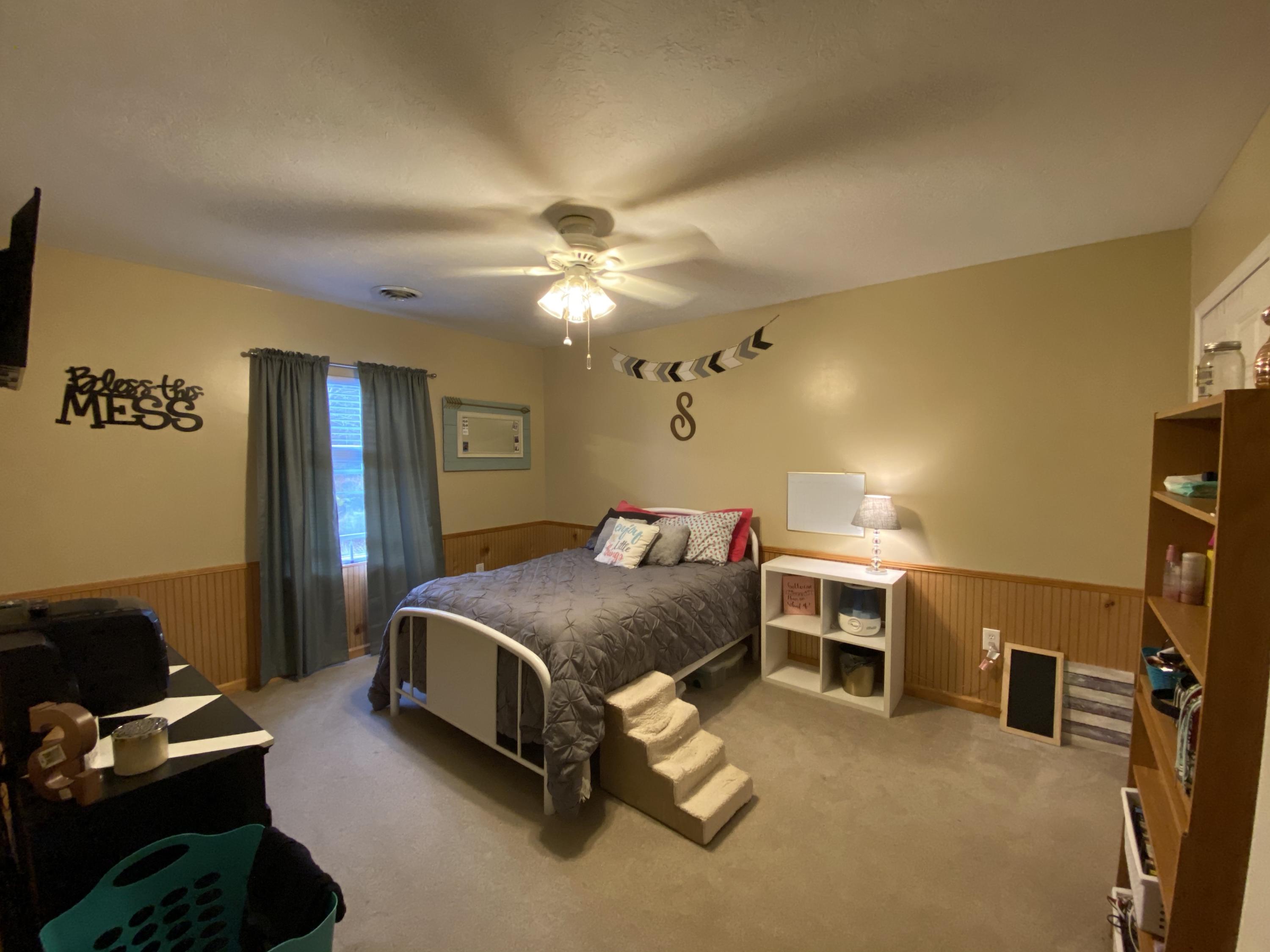 2211 Riner Road Christiansburg, VA 24073 - Photo 10 of 15 a spacious bedroom with a bed and a chandelier