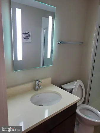 a bathroom with a sink a toilet and a mirror