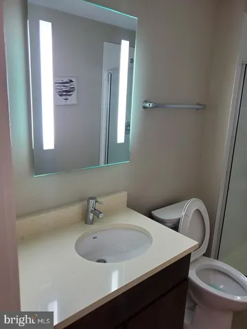 a bathroom with a sink a toilet and a mirror