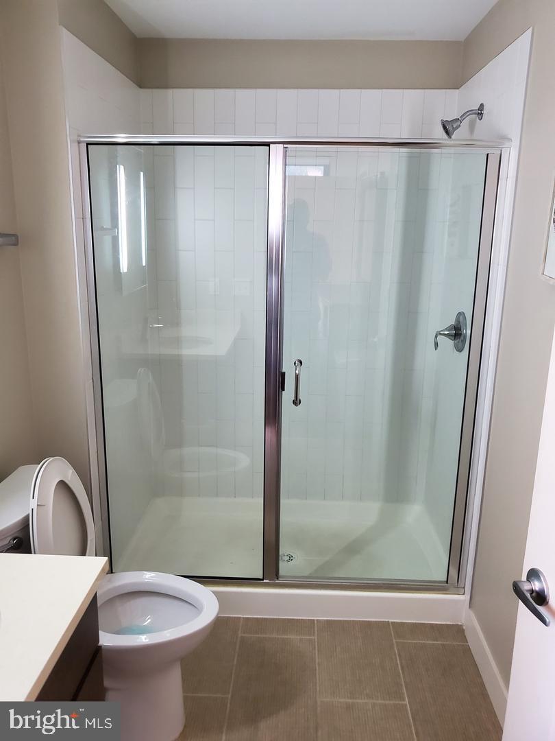1320 Fenwick Lane, Unit 700 Silver Spring, MD 20910 - Photo 7 of 11 a bathroom with a shower a toilet and a sink