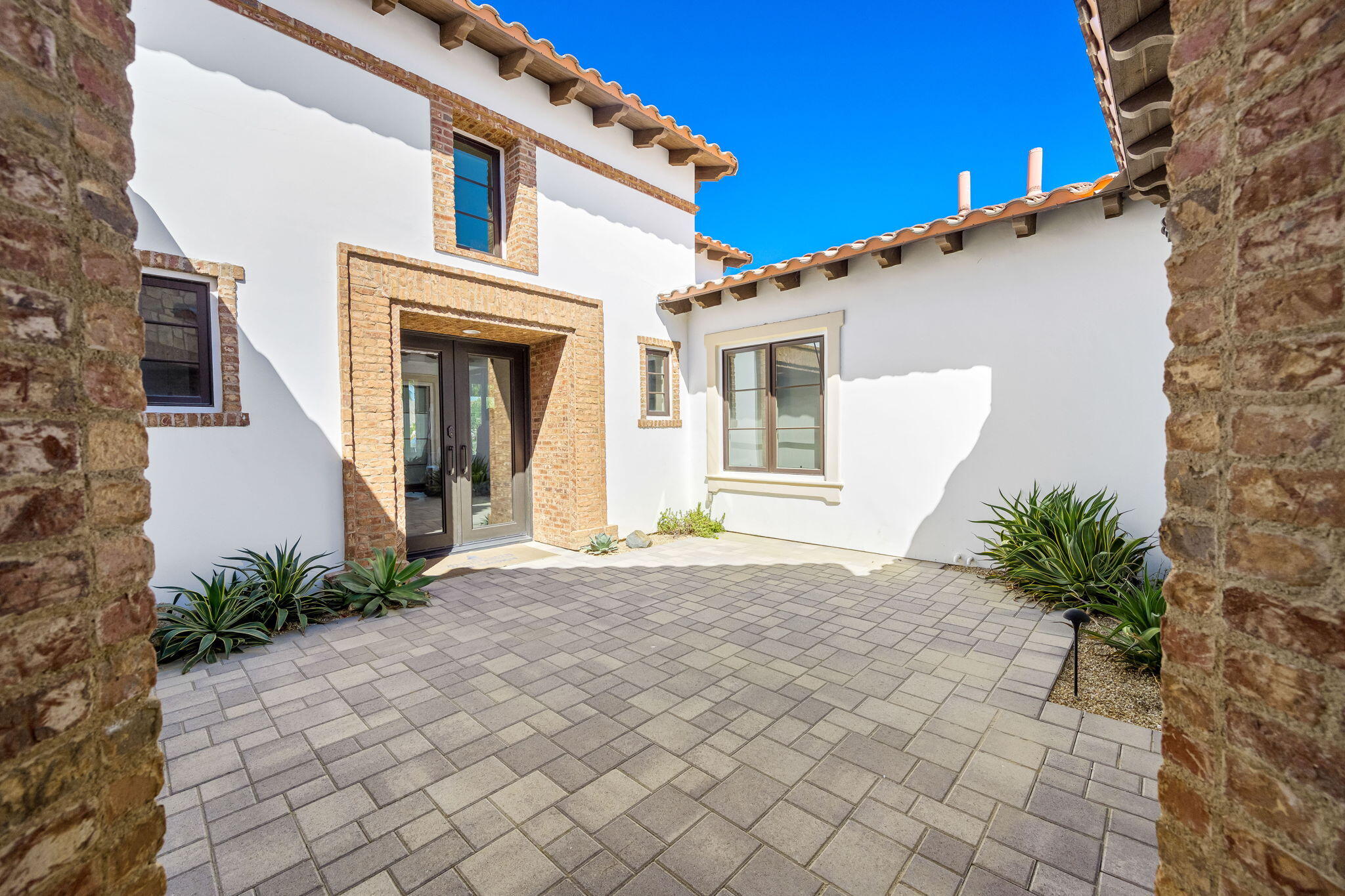 59805 Seville La Quinta, CA 92253 - Photo 11 of 61 a view of a white house with a small yard and plants