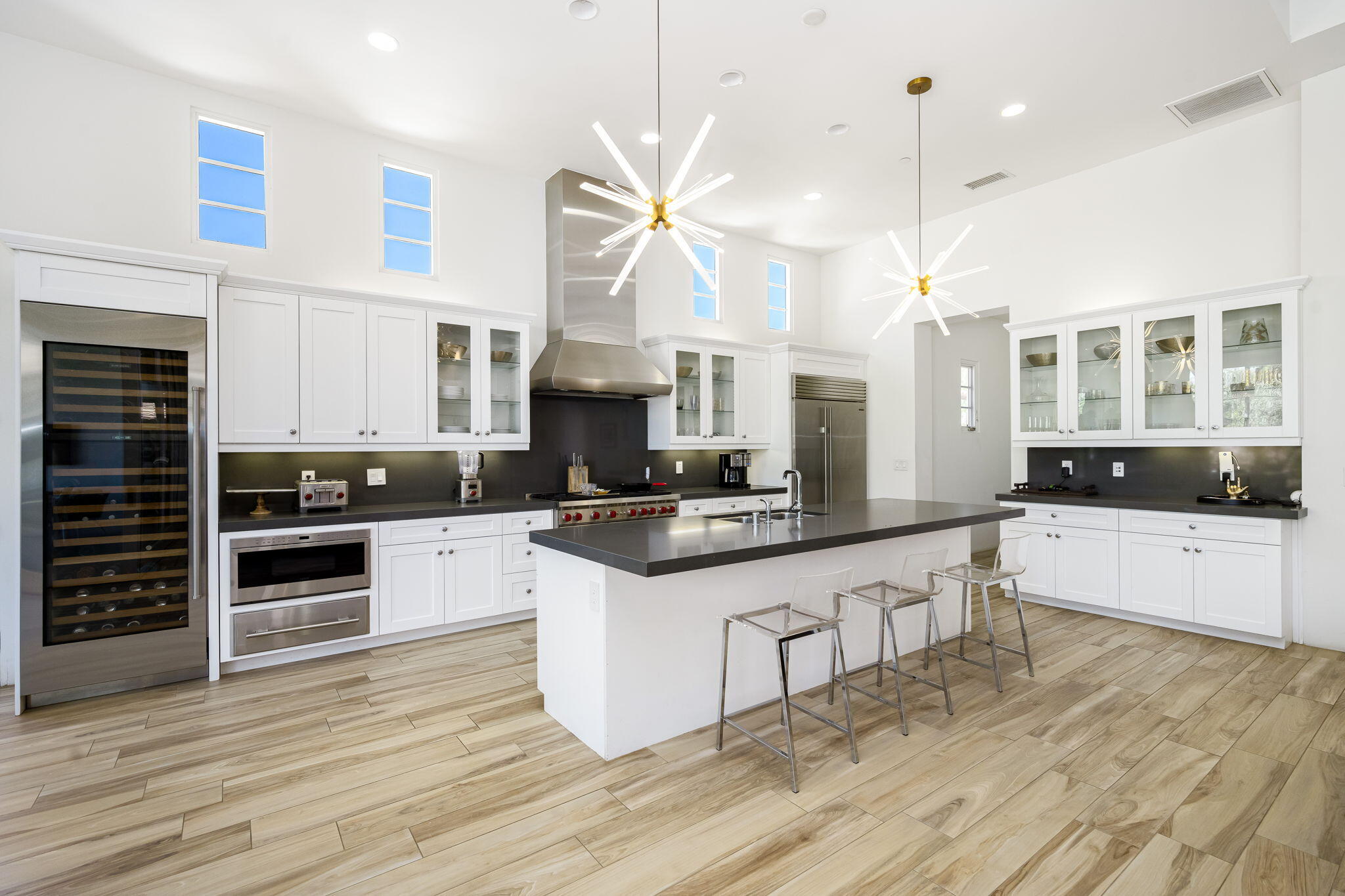 59805 Seville La Quinta, CA 92253 - Photo 18 of 61 a kitchen with stainless steel appliances a stove a sink and white cabinets