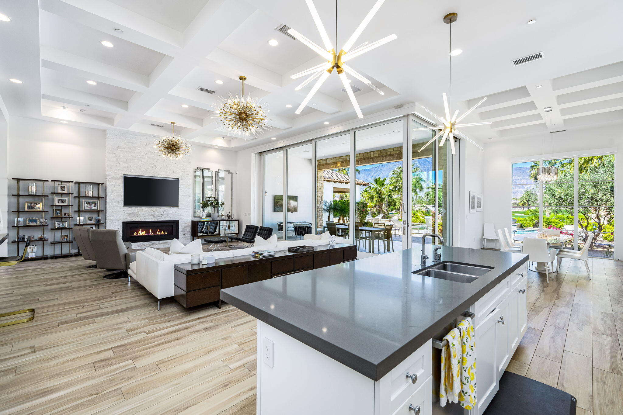 59805 Seville La Quinta, CA 92253 - Photo 21 of 61 a kitchen with sink stove and living room view