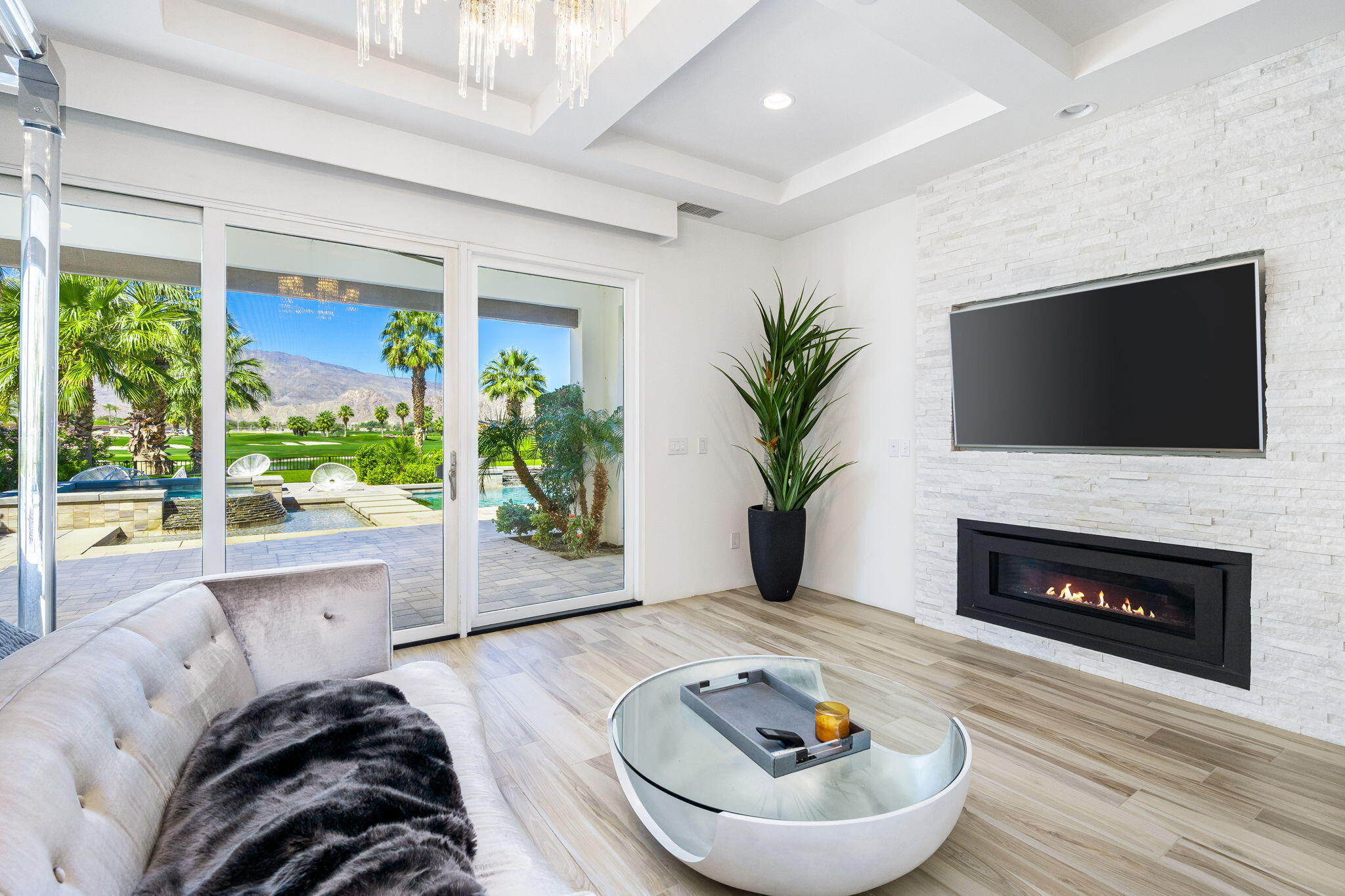 59805 Seville La Quinta, CA 92253 - Photo 26 of 61 a living room with furniture a large window and a fireplace