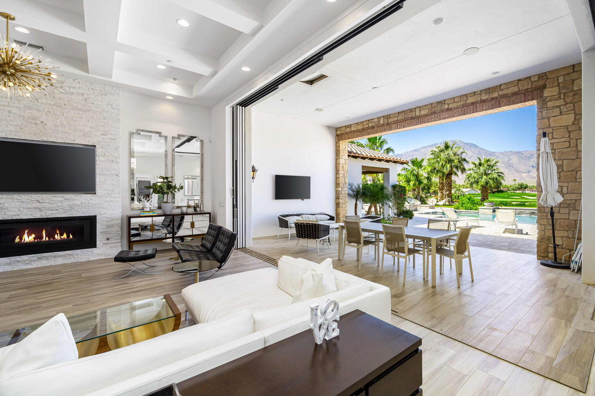 59805 Seville La Quinta, CA 92253 - Photo 30 of 61 a living room with fireplace furniture and a large window