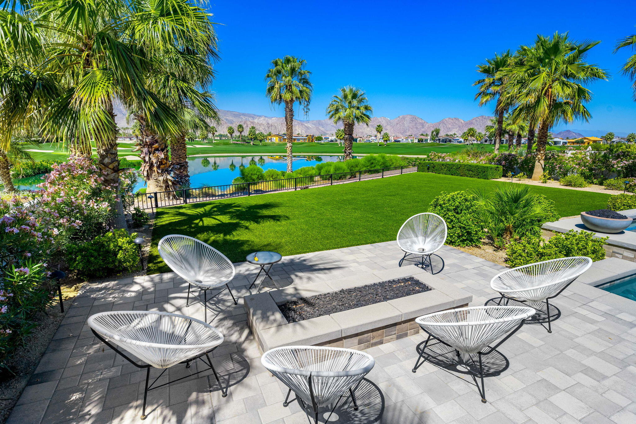 59805 Seville La Quinta, CA 92253 - Photo 36 of 61 a view of a patio with table and chairs potted plants and palm tree