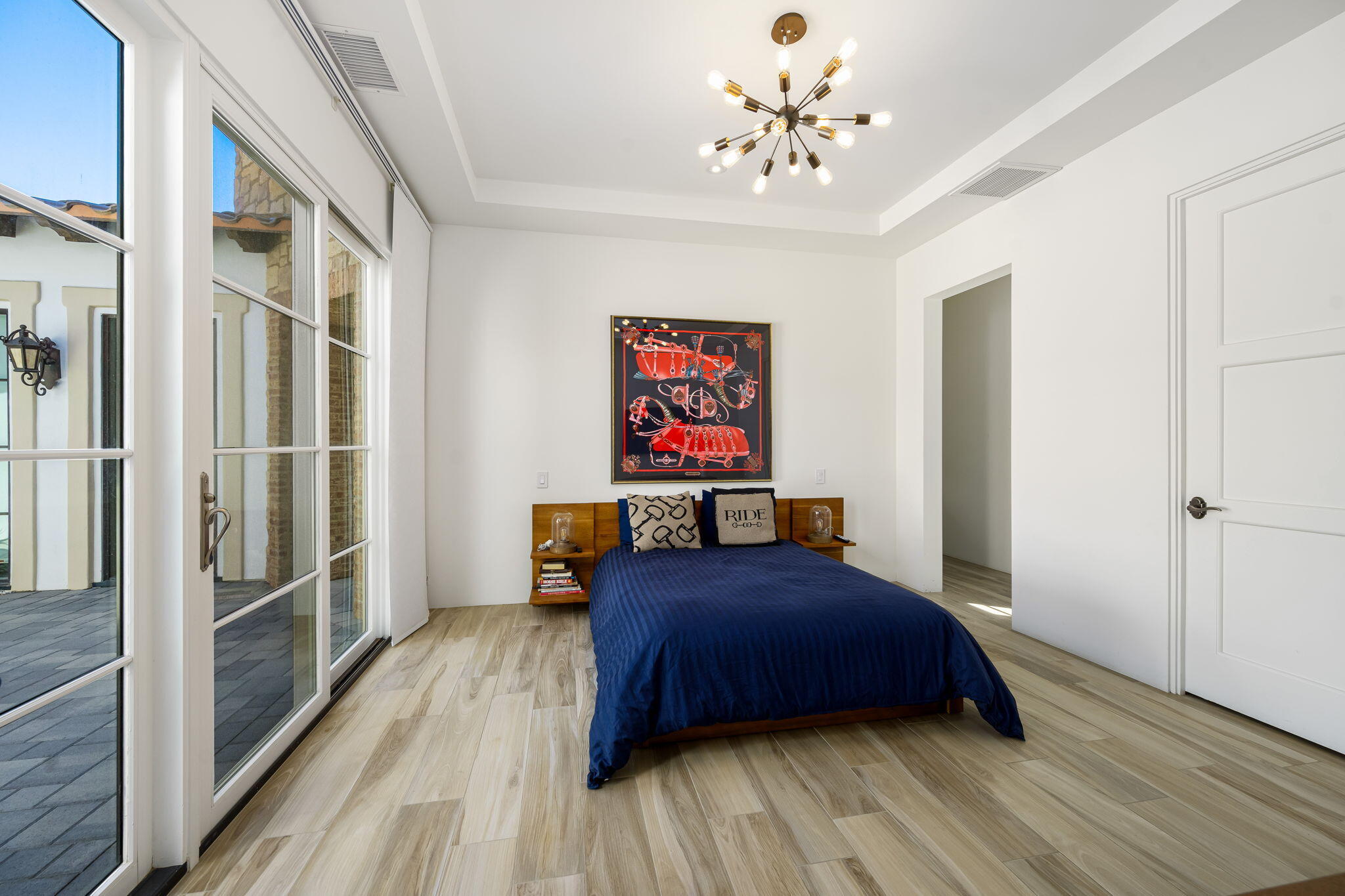 59805 Seville La Quinta, CA 92253 - Photo 38 of 61 a bedroom with a bed and a chandelier