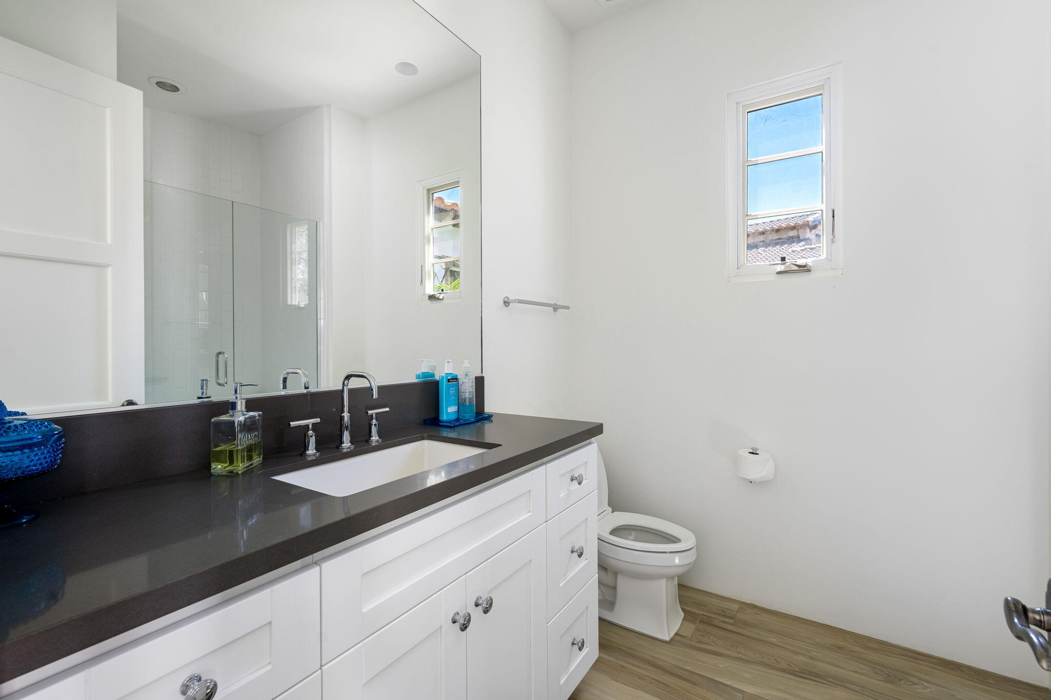 59805 Seville La Quinta, CA 92253 - Photo 47 of 61 a bathroom with a granite countertop sink a toilet and a mirror