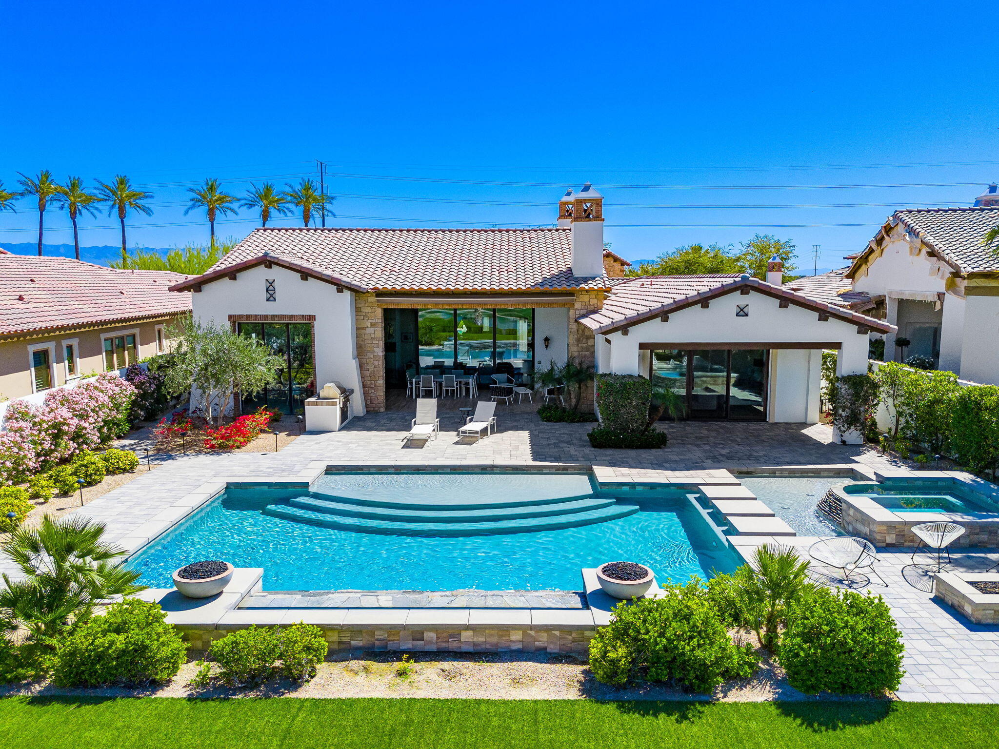 59805 Seville La Quinta, CA 92253 - Photo 48 of 61 a front view of a house with garden and sitting area