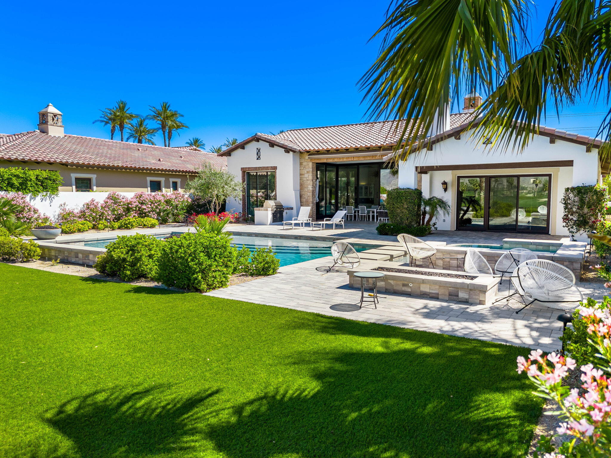 59805 Seville La Quinta, CA 92253 - Photo 49 of 61 a view of a house with a swimming pool and a chairs