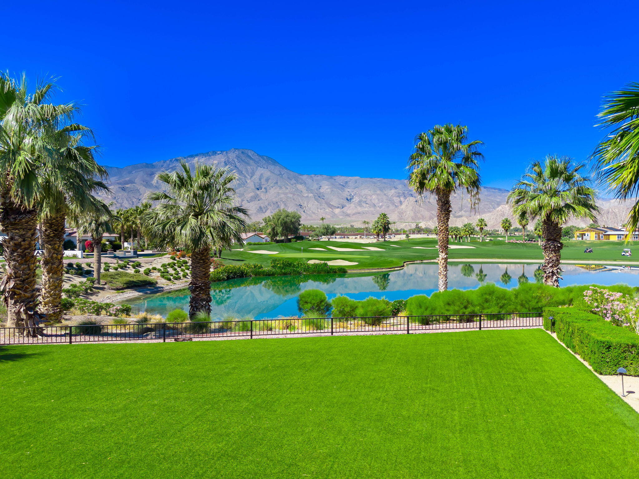 59805 Seville La Quinta, CA 92253 - Photo 52 of 61 a view of a garden with a building in the background