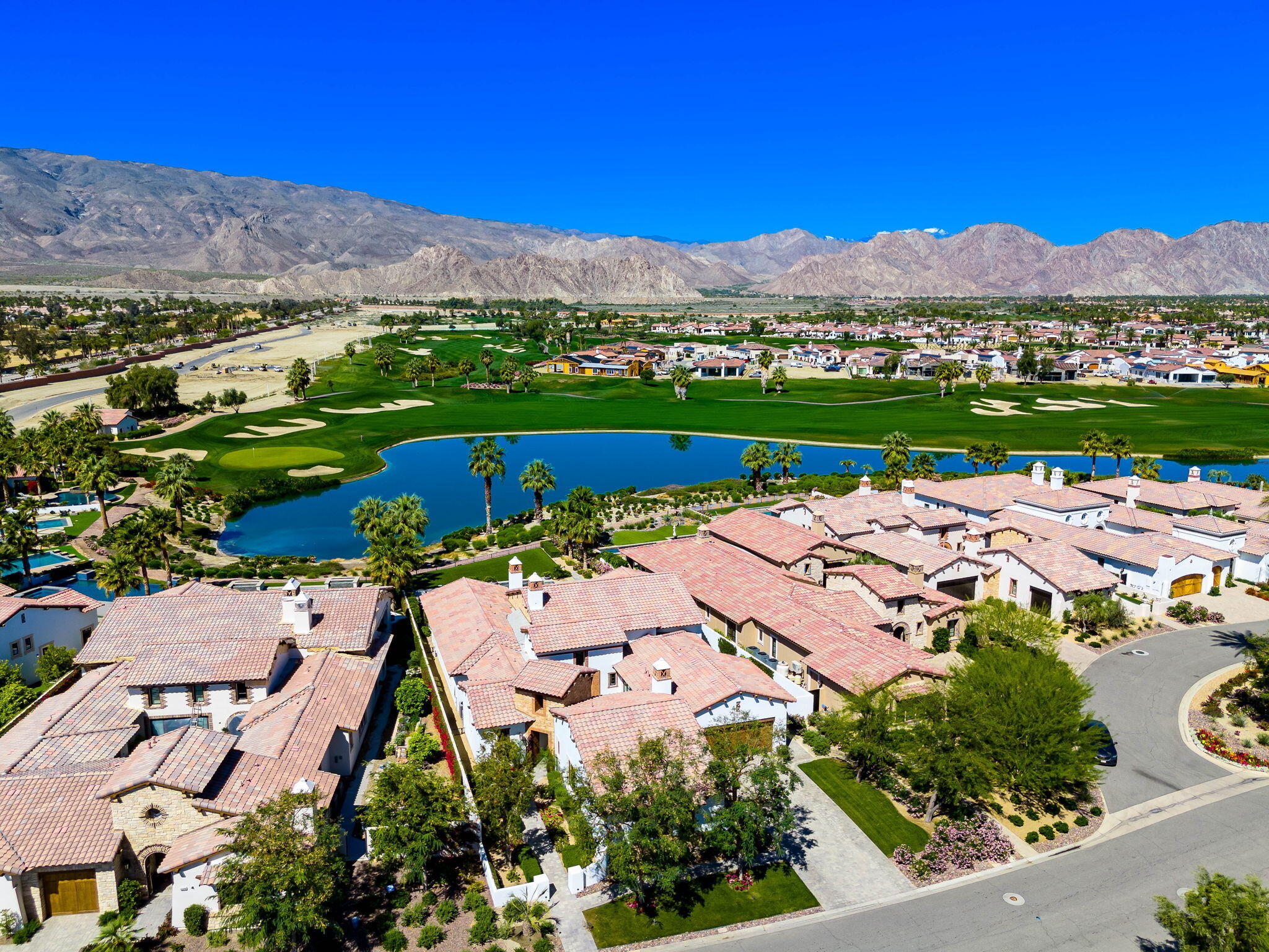 59805 Seville La Quinta, CA 92253 - Photo 6 of 61 an aerial view of a city with lots of residential buildings ocean and mountain view in back