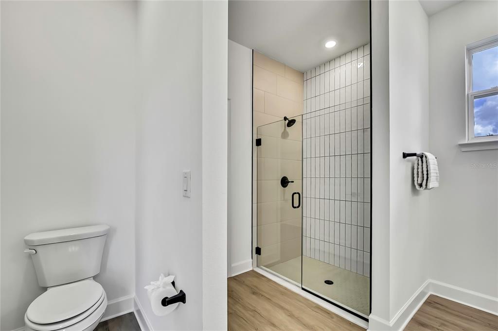 6589 Freeport Drive Spring Hill, FL 34608 - Photo 28 of 63 a bathroom with a shower and toilet