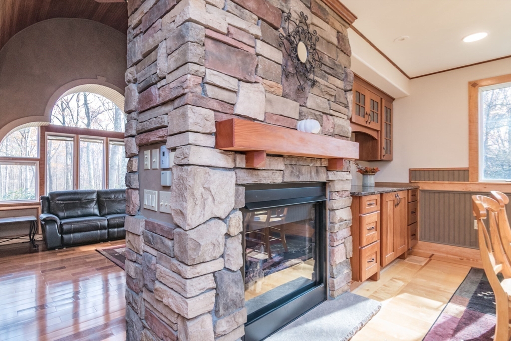 29 Rattle Hill Road Southampton, MA 01073 - Photo 12 of 42 a living room with furniture a fireplace and a large window
