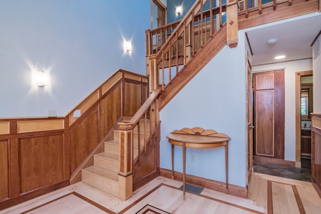29 Rattle Hill Road Southampton, MA 01073 - Photo 20 of 42 a view of staircase with lots of frames on wall and wooden floor