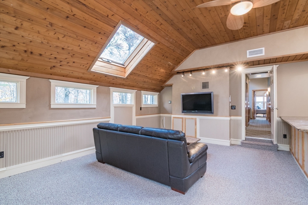 29 Rattle Hill Road Southampton, MA 01073 - Photo 28 of 42 a living room with furniture and a flat screen tv