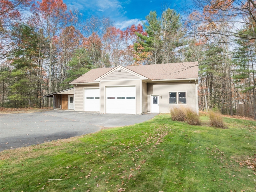 29 Rattle Hill Road Southampton, MA 01073 - Photo 38 of 42 a front view of a house with a garden and yard