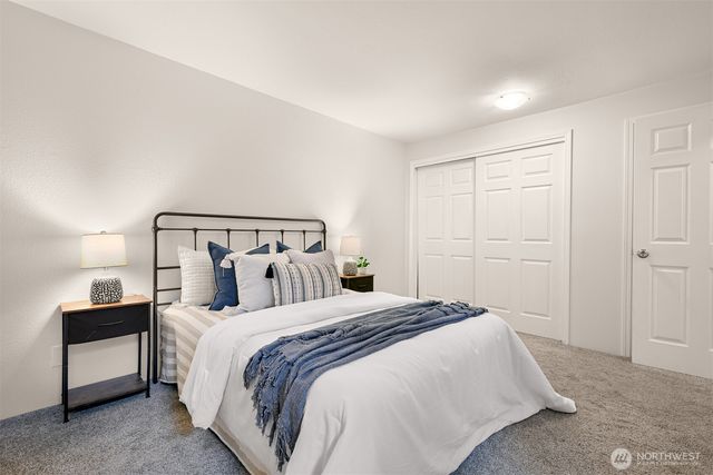 a bedroom with a bed and a lamp